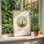 Spiritual tree print with sacred geometry patterns on off-white background on a window sill with light streaming in next to green potted plant. 